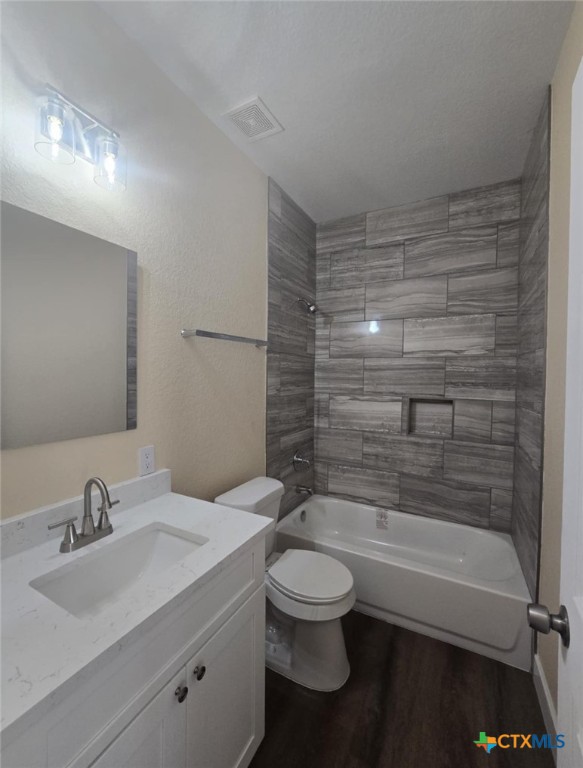 410 Trinity Street Luling, TX 78648 - Photo 7 of 10 a bathroom with a bathtub shower sink vanity and toilet