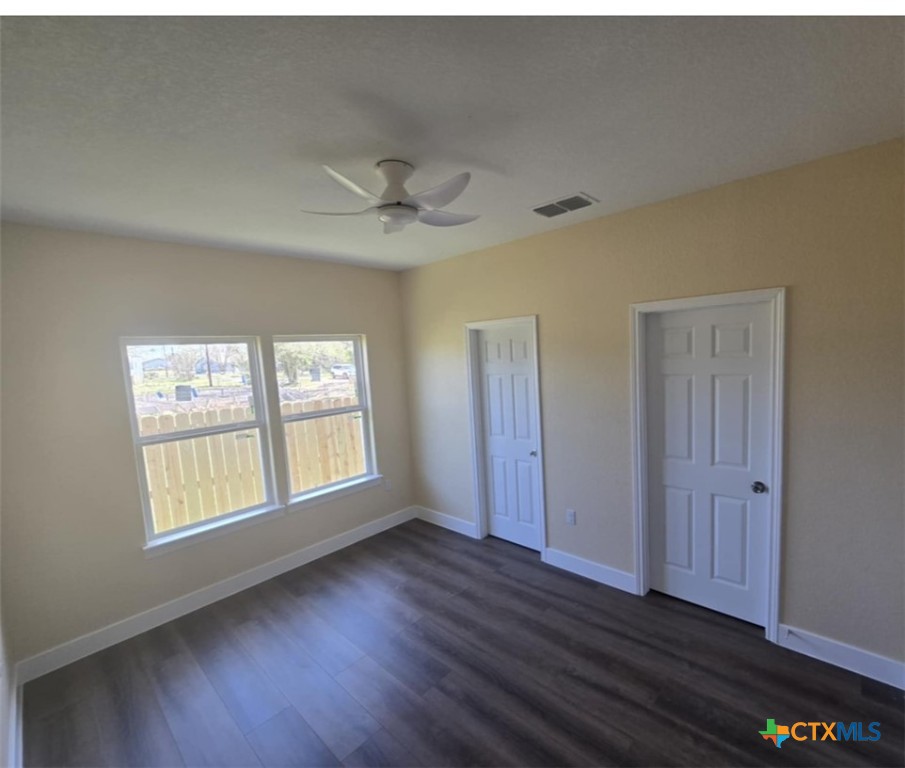 410 Trinity Street Luling, TX 78648 - Photo 9 of 10 a view of an empty room with wooden floor and a window