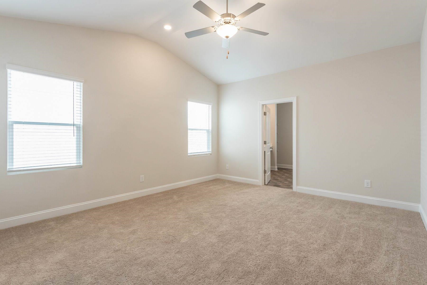 310 Access Drive Youngsville, NC 27596 - Photo 11 of 19 an empty room with windows and fan