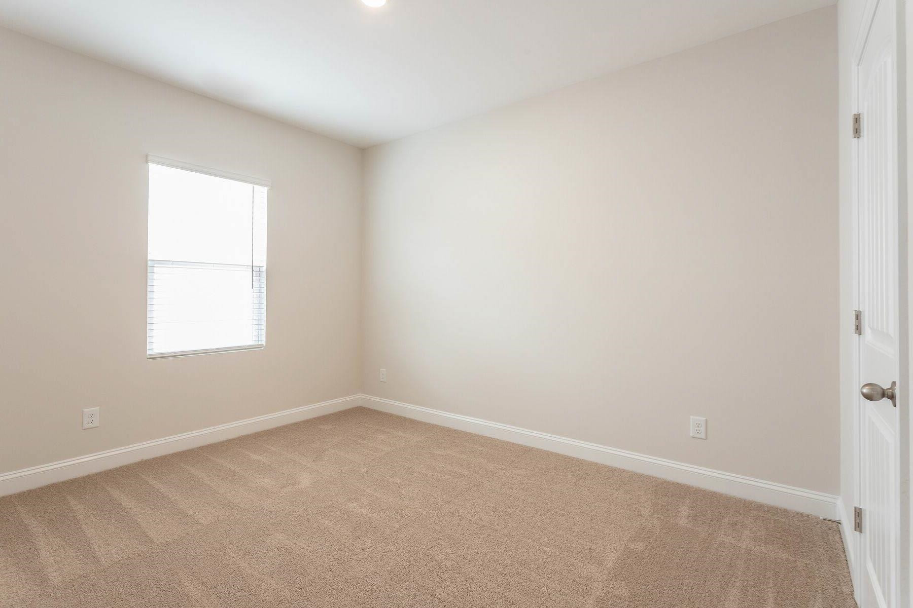 310 Access Drive Youngsville, NC 27596 - Photo 17 of 19 an empty room with a window