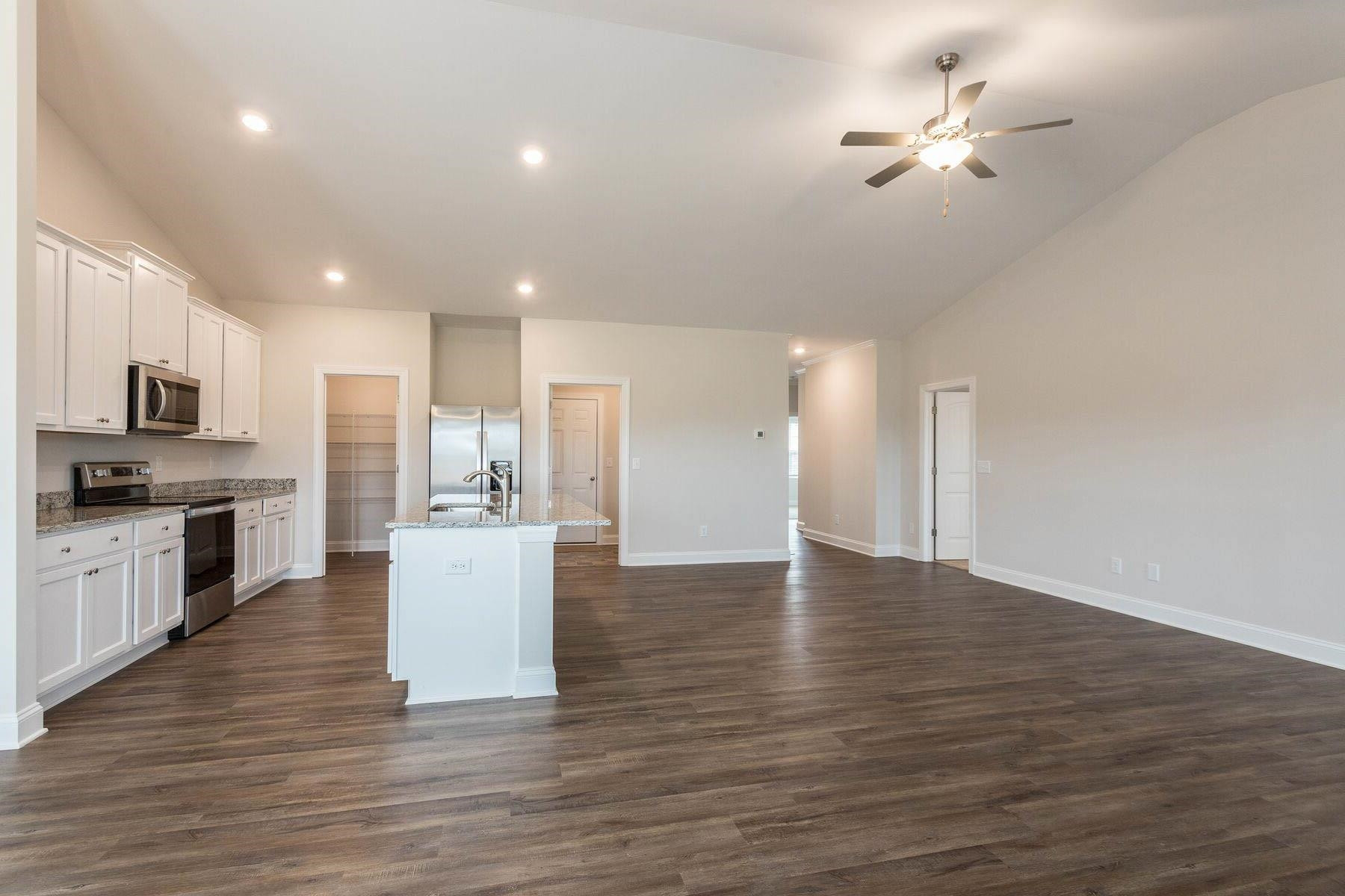 310 Access Drive Youngsville, NC 27596 - Photo 5 of 19 a view of a kitchen with a sink dishwasher a stove and a refrigerator