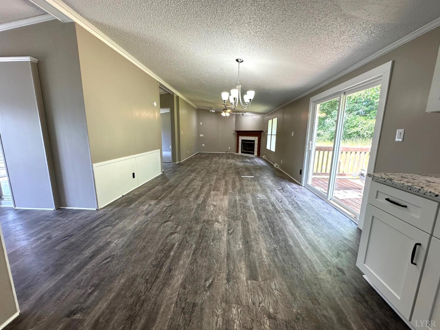 6337 Bethany Road Rustburg, VA 24588 - Photo 5 of 24 a view of empty room with wooden floor and fan