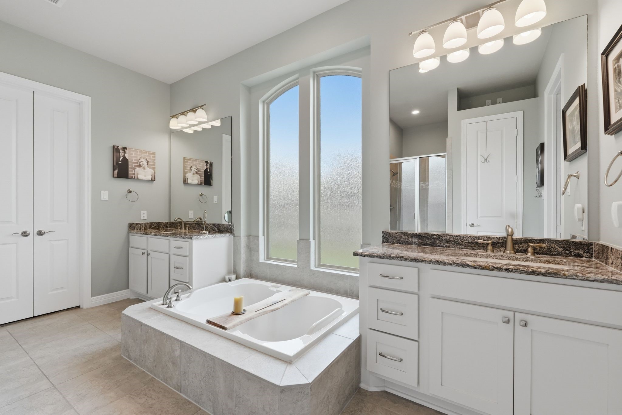 27705 South Slate Hills Lane Spring, TX 77386 - Photo 18 of 45 Bright primary ensuite showcasing custom granite counters and timeless white cabinetry.