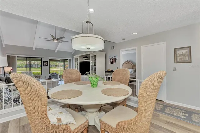 a view of a hallway with wooden floor and a living room
