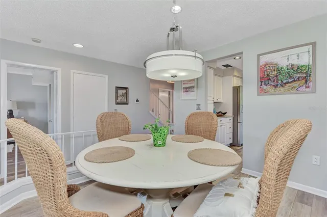 a bedroom with a bed a large window and a flat tv screen on dresser
