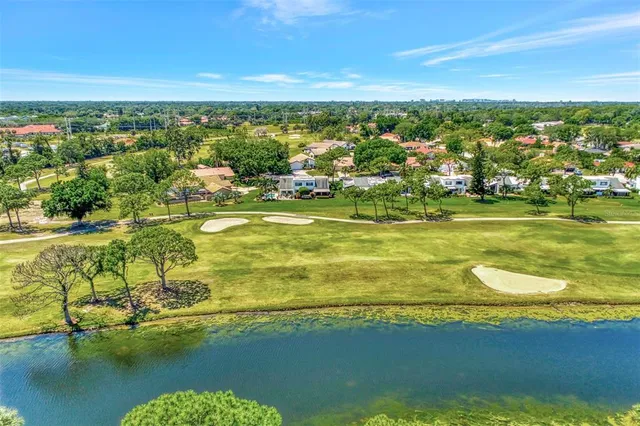 a view of a garden with flowers and trees
