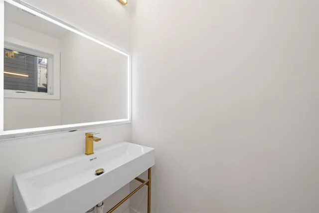 a bathroom with a sink and a window