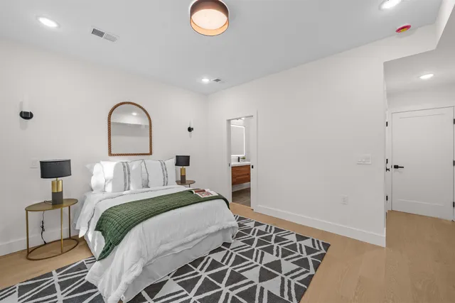 a bedroom with a bed and a lamp