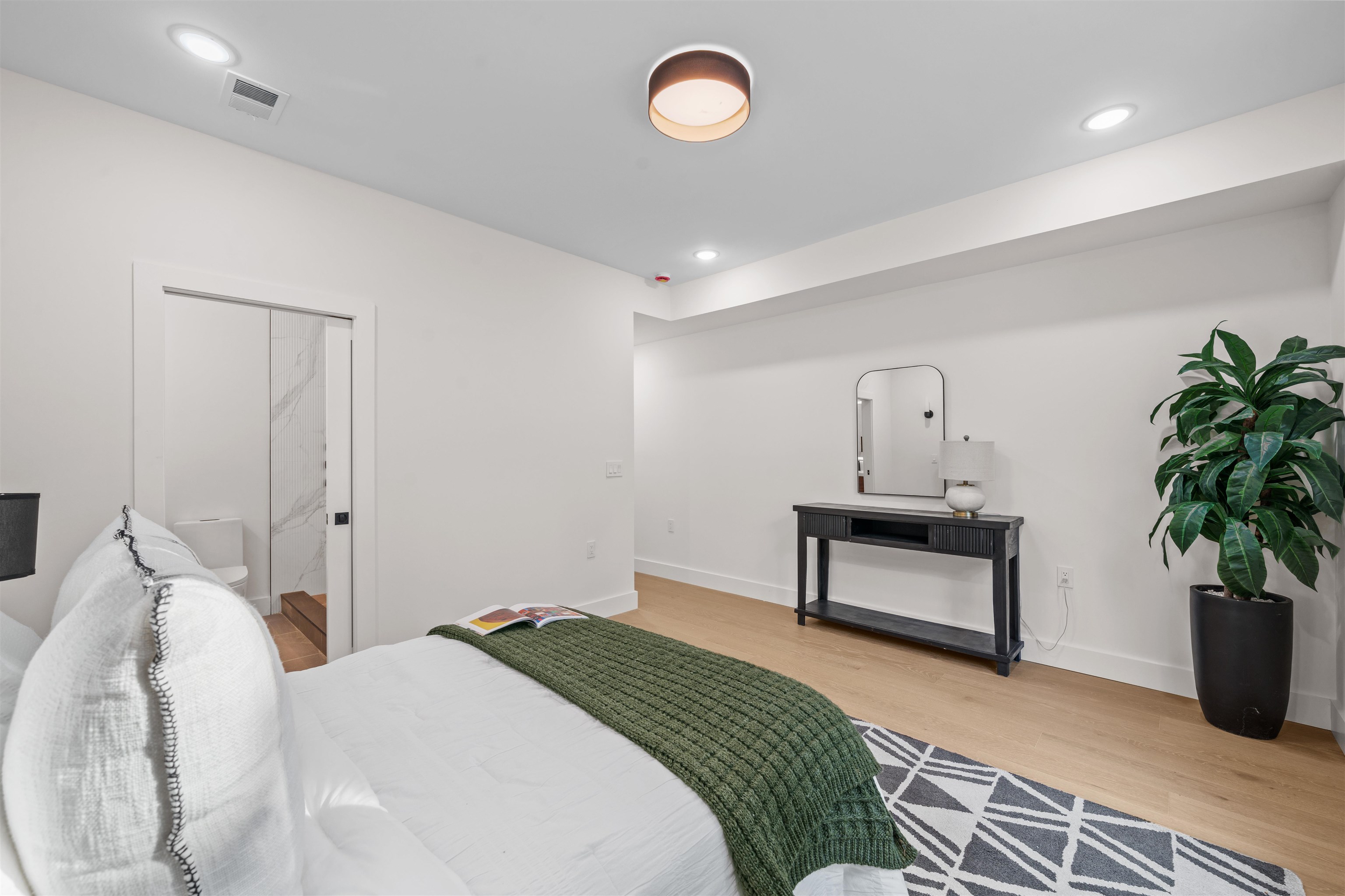 249.5 Halladay Street, Unit 1 Jersey City, NJ 07304 - Photo 15 of 31 a bedroom with bed and a potted plant