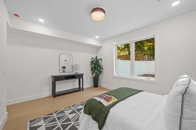 a bedroom with a bed and a table