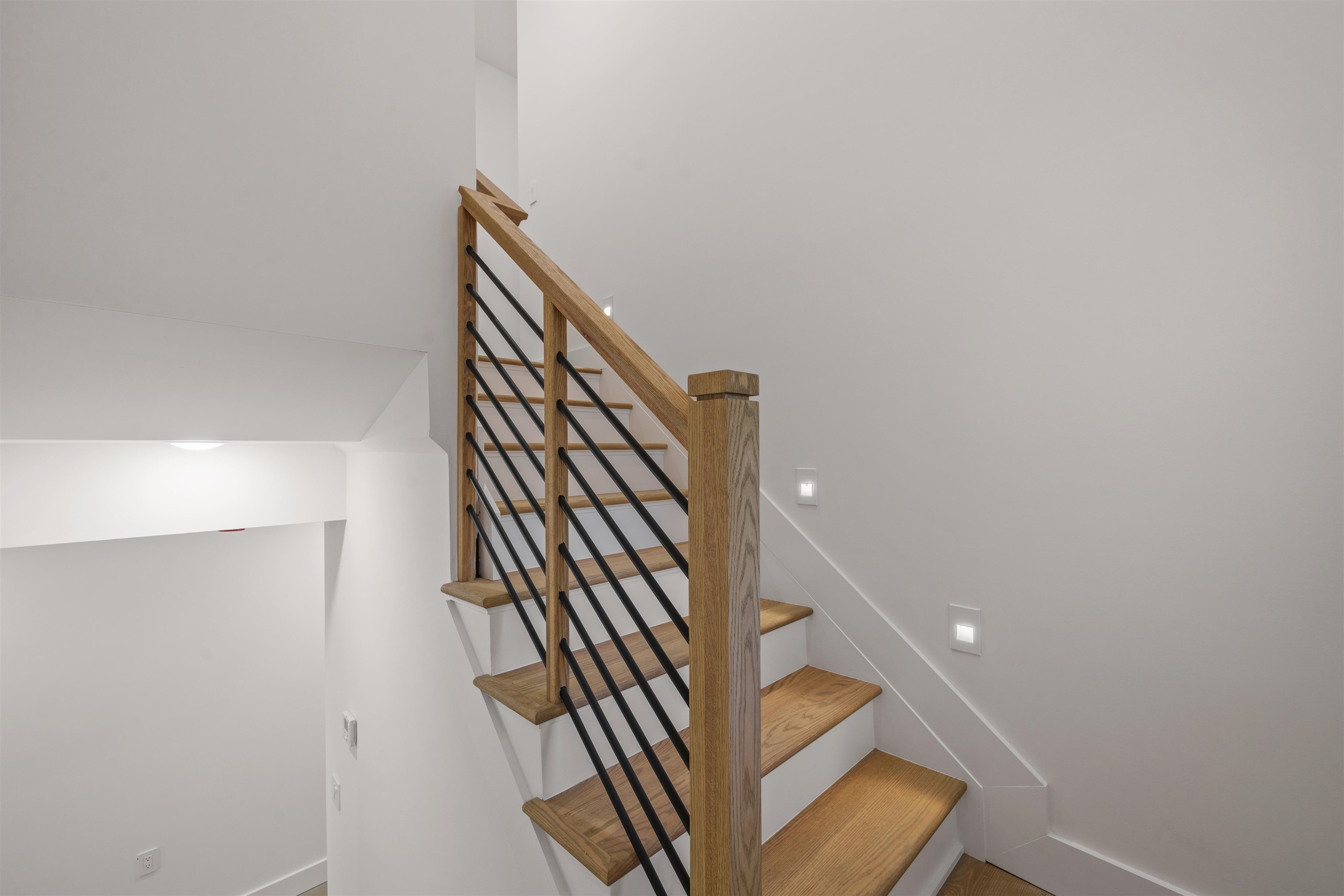 249.5 Halladay Street, Unit 1 Jersey City, NJ 07304 - Photo 19 of 31 a view of staircase with wooden floor and white walls