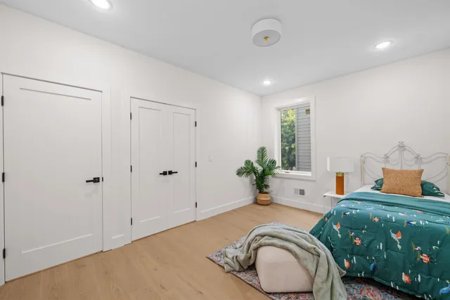 a bedroom with a bed and a chair