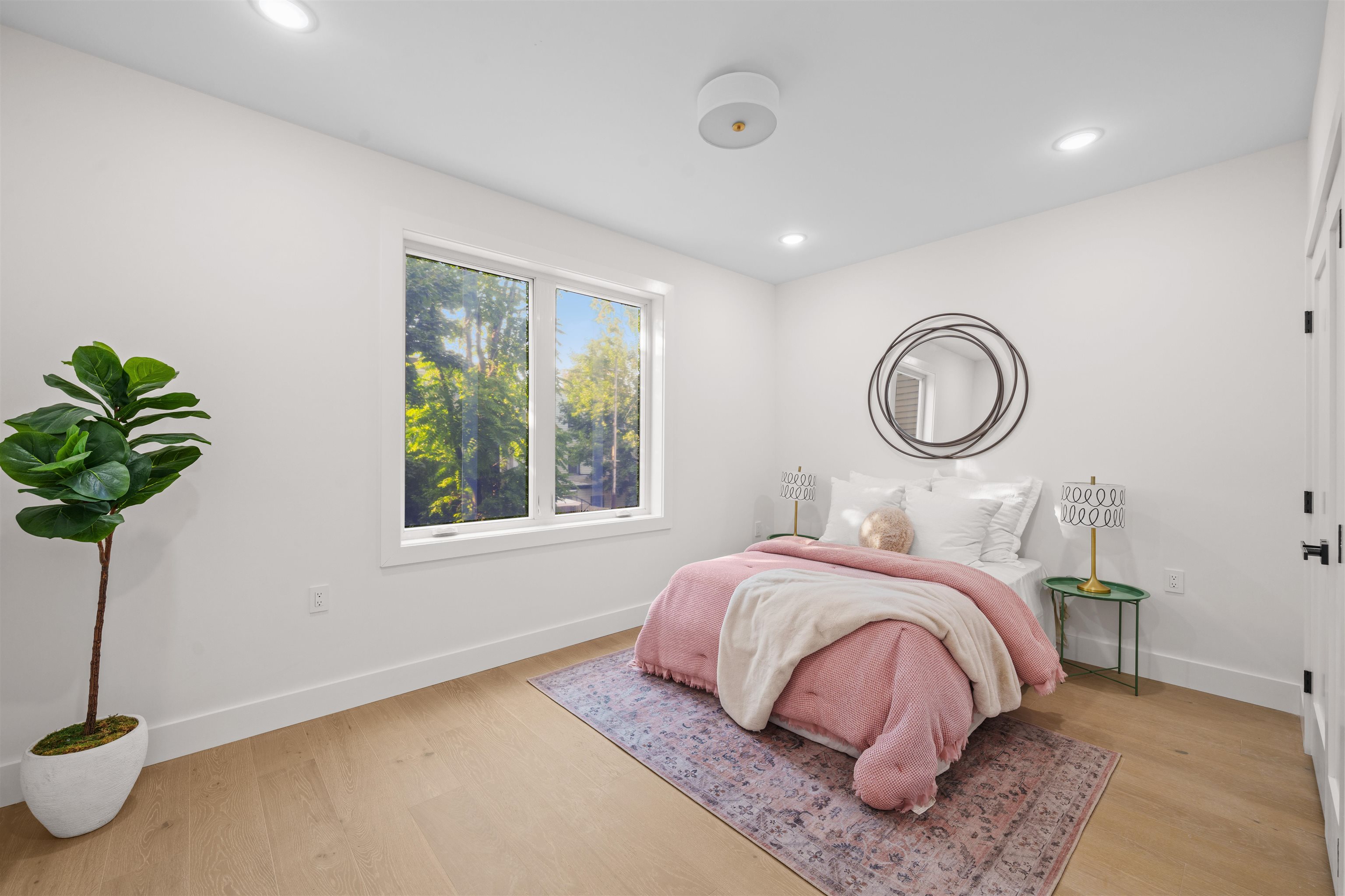 249.5 Halladay Street, Unit 1 Jersey City, NJ 07304 - Photo 23 of 31 a bedroom with a bed lamp and a potted plant