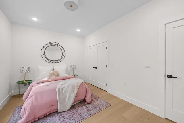 a bedroom with a bed and a chandelier