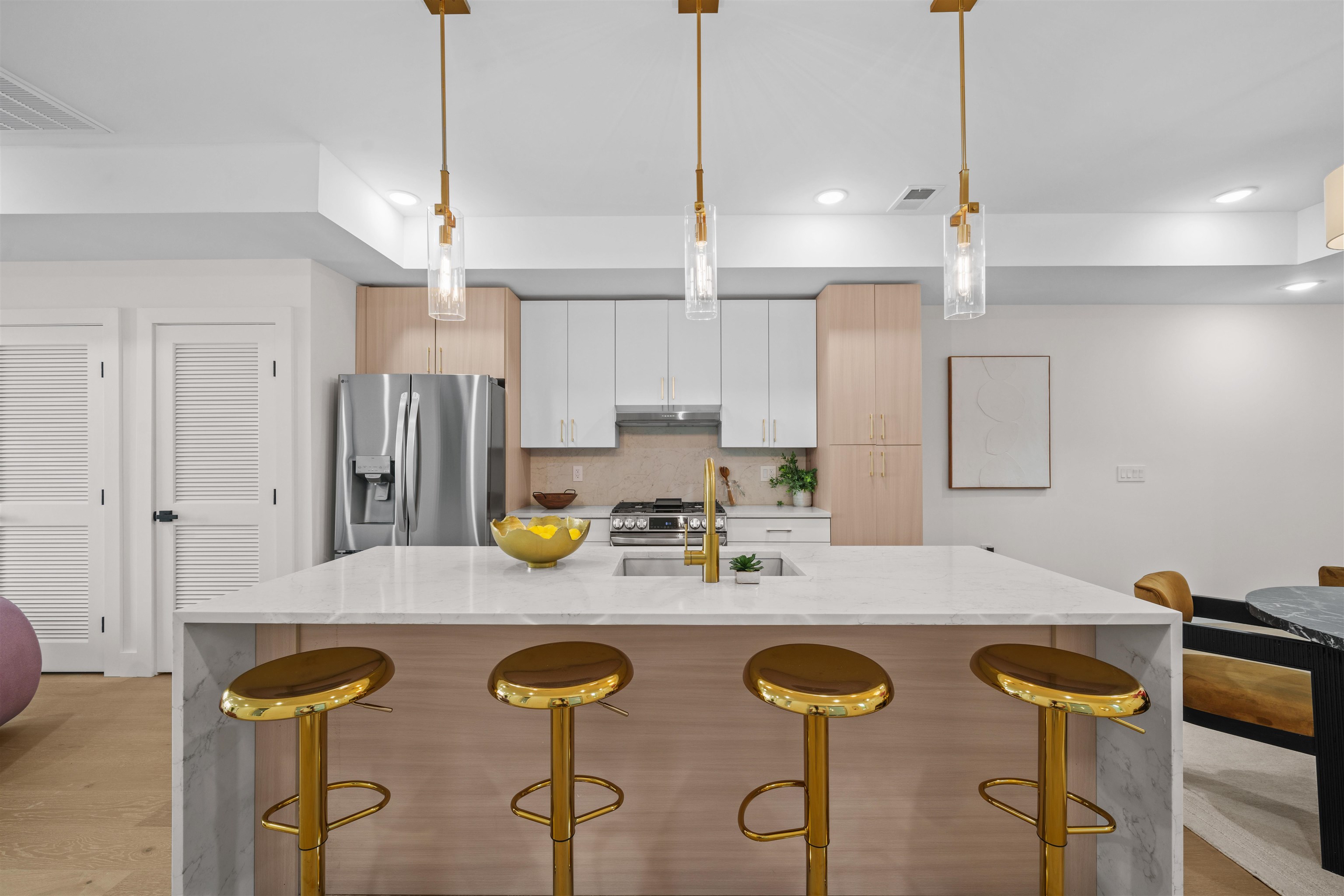 249.5 Halladay Street, Unit 1 Jersey City, NJ 07304 - Photo 4 of 31 a kitchen with stainless steel appliances granite countertop a sink a stove a refrigerator and island with wooden floor