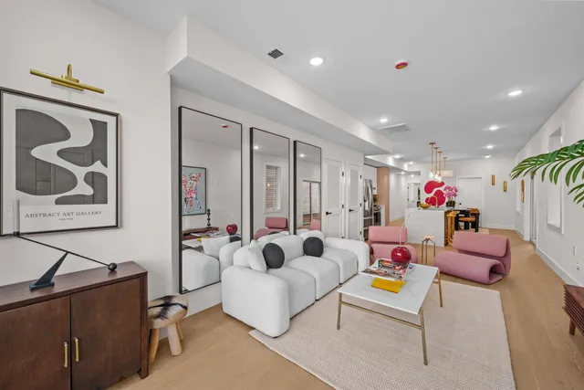 a living room with furniture and flowers