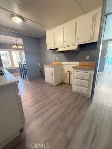 a view of cabinets and wooden floor