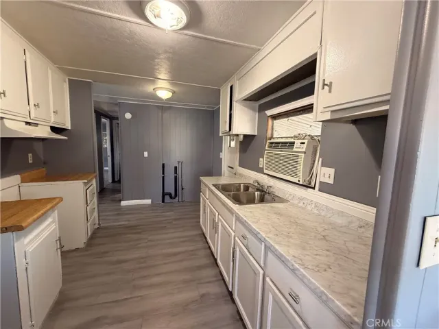 a kitchen with counter top space and wooden floor