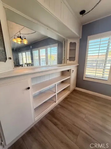 a view of living room with wooden floor and fan