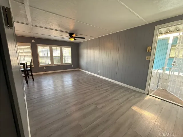 an empty room with wooden floor and a window