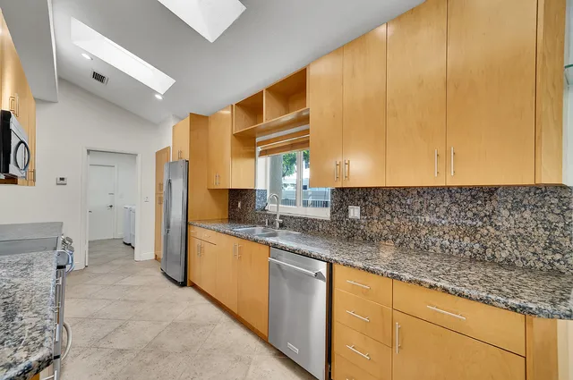 a bathroom with a sink a bathtub and next to a window