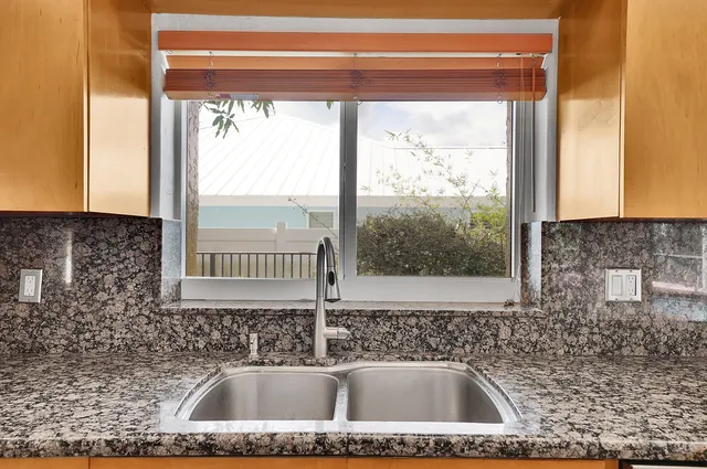 a dining room with furniture a chandelier and window