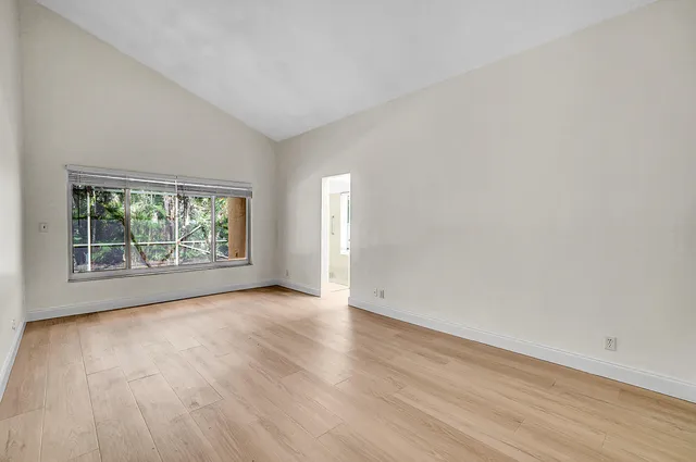 a bathroom with a sink a toilet a large mirror and a window