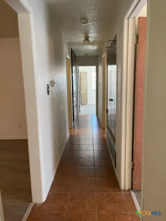 a view of a hallway with a dining area