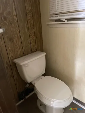 a white toilet sitting next to a shower