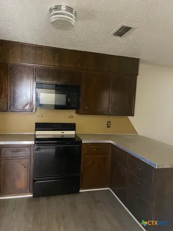 a kitchen with stainless steel appliances a stove and a microwave