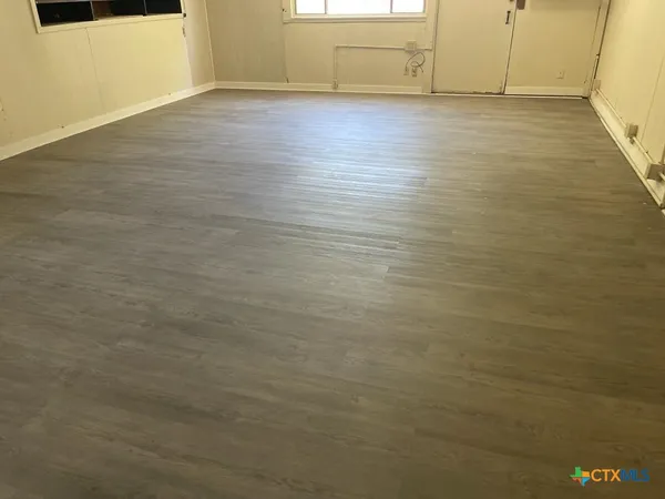 a view of a room with wooden floor