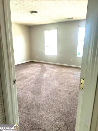a view of an empty room and window