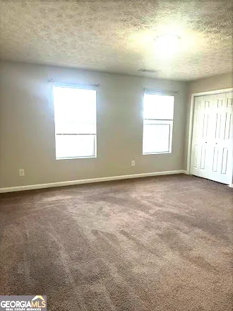 an empty room with a empty space and windows