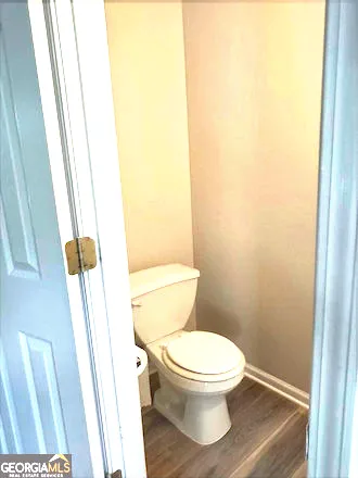a white toilet sitting next to a sink