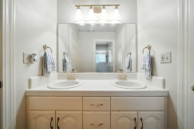 a bathroom with a sink vanity and a mirror