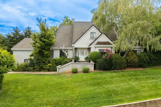 a front view of a house with garden