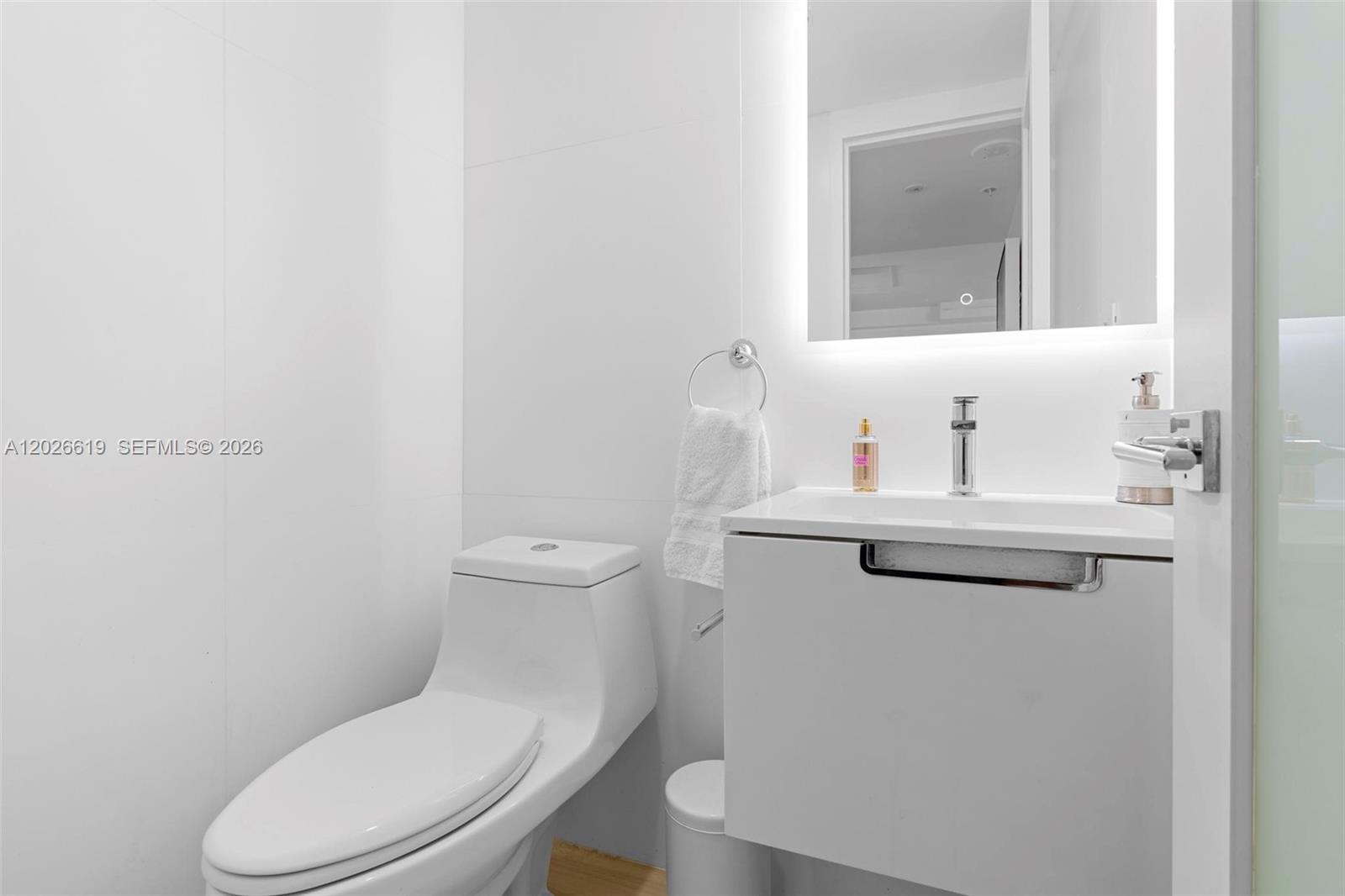 1500 Bay Road, Unit 1268S Miami Beach, FL 33139 - Photo 6 of 31 a bathroom with a toilet sink and mirror