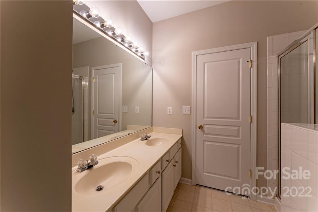 3106 Tanzanite Circle Fort Mill, SC 29708 - Photo 21 of 36 a bathroom with a double vanity sink and a mirror