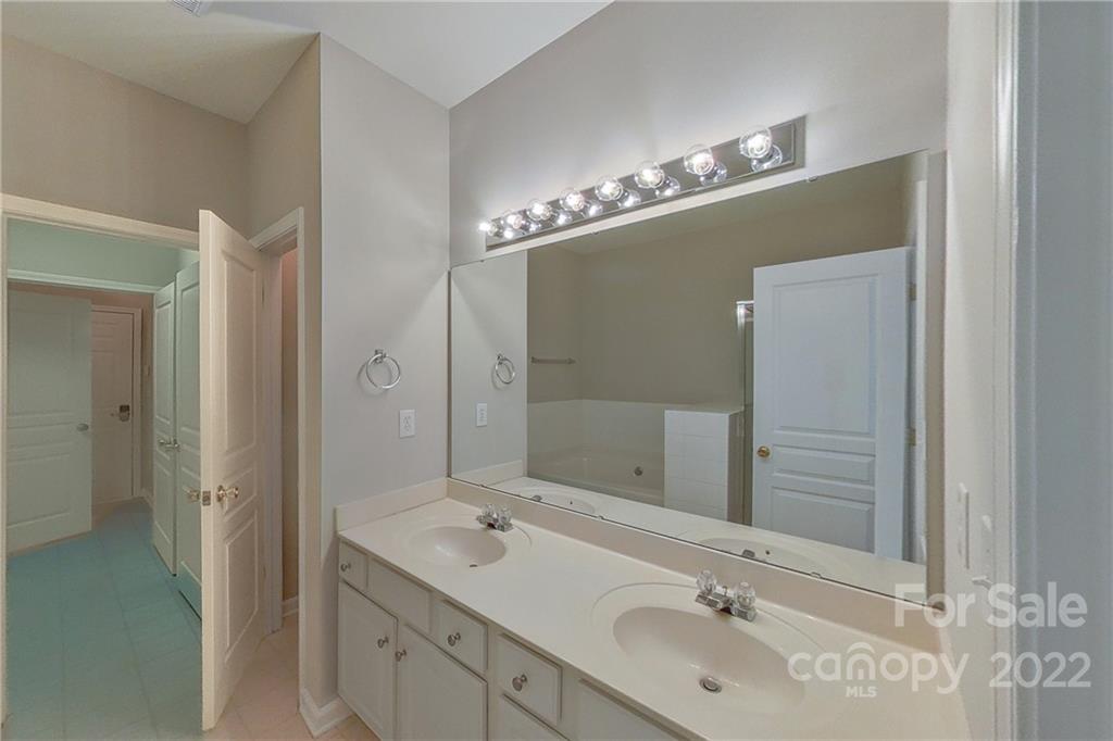 3106 Tanzanite Circle Fort Mill, SC 29708 - Photo 22 of 36 a bathroom with a double vanity sink and a mirror