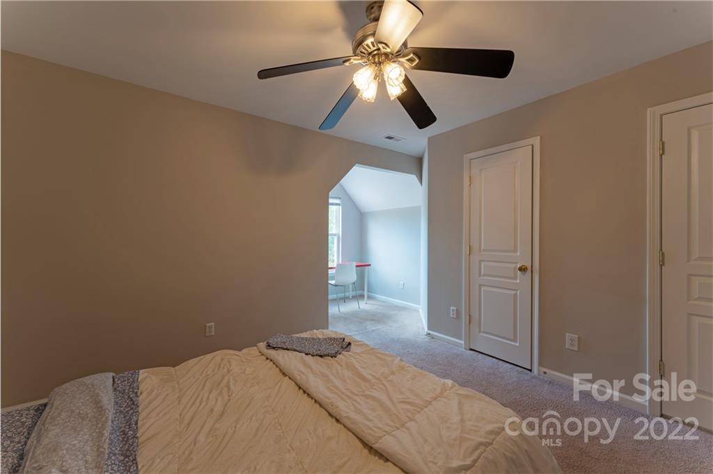 3106 Tanzanite Circle Fort Mill, SC 29708 - Photo 26 of 36 a bedroom with a bed and a chandelier
