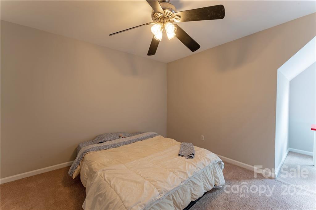 3106 Tanzanite Circle Fort Mill, SC 29708 - Photo 27 of 36 a bedroom with a bed and a fan
