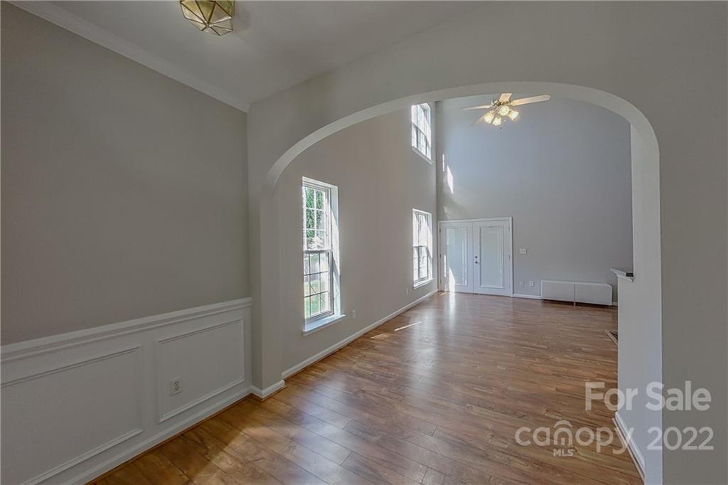 3106 Tanzanite Circle Fort Mill, SC 29708 - Photo 3 of 36 a view of an empty room with a window and wooden floor
