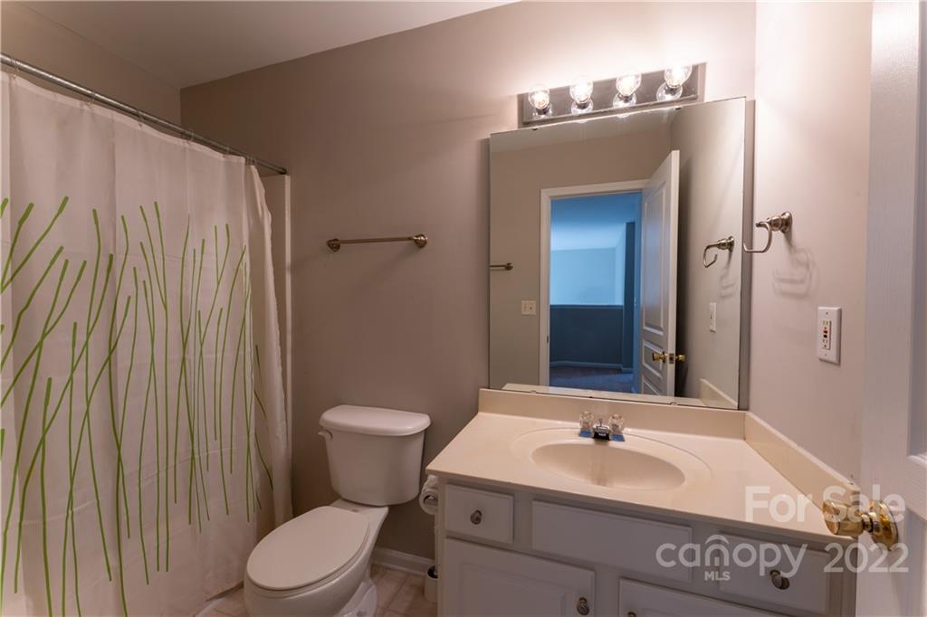 3106 Tanzanite Circle Fort Mill, SC 29708 - Photo 32 of 36 a bathroom with a toilet a sink and mirror