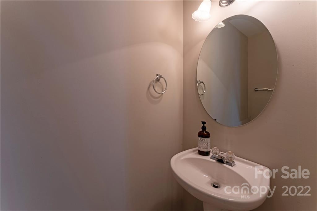 3106 Tanzanite Circle Fort Mill, SC 29708 - Photo 33 of 36 a bathroom with a sink and mirror