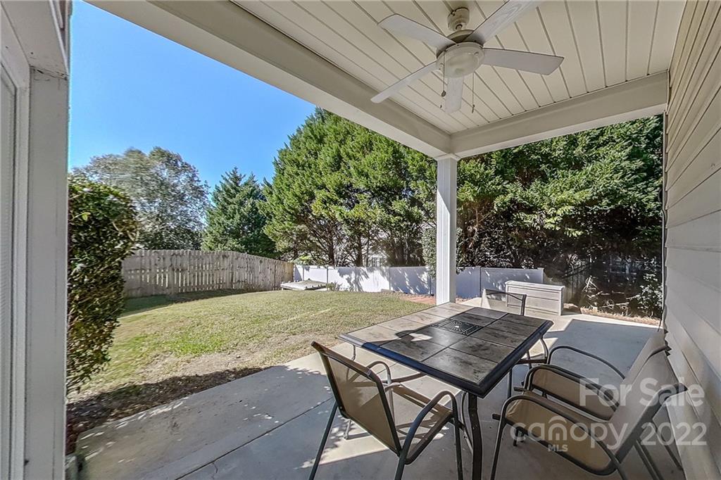 3106 Tanzanite Circle Fort Mill, SC 29708 - Photo 34 of 36 a view of a patio with table and chairs and floor to ceiling window with an outdoor space