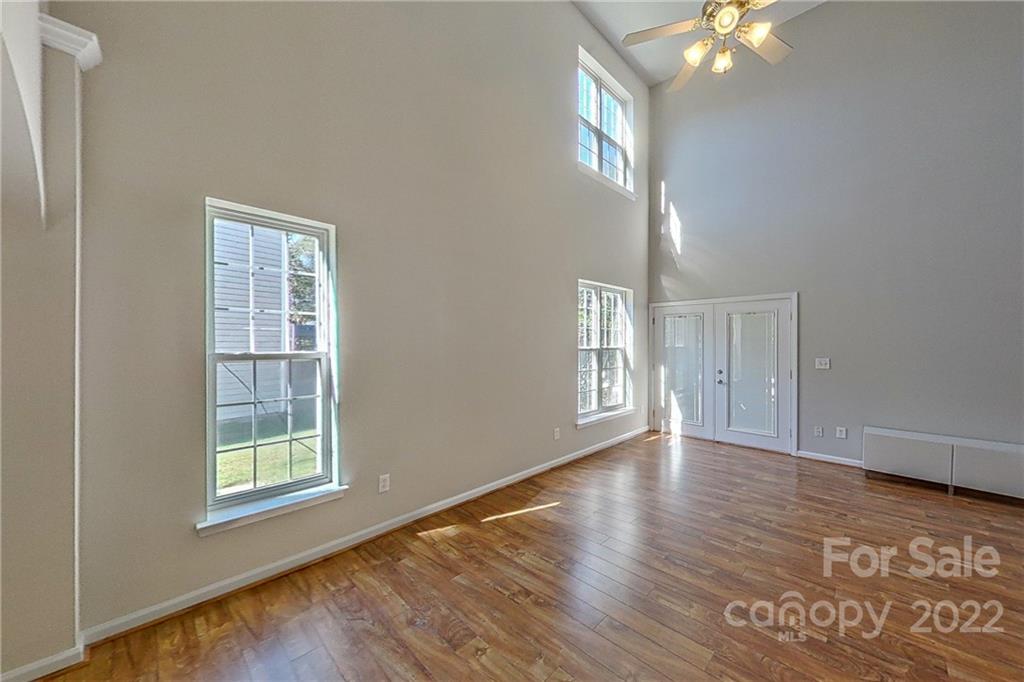 3106 Tanzanite Circle Fort Mill, SC 29708 - Photo 4 of 36 a view of an empty room with wooden floor and a window