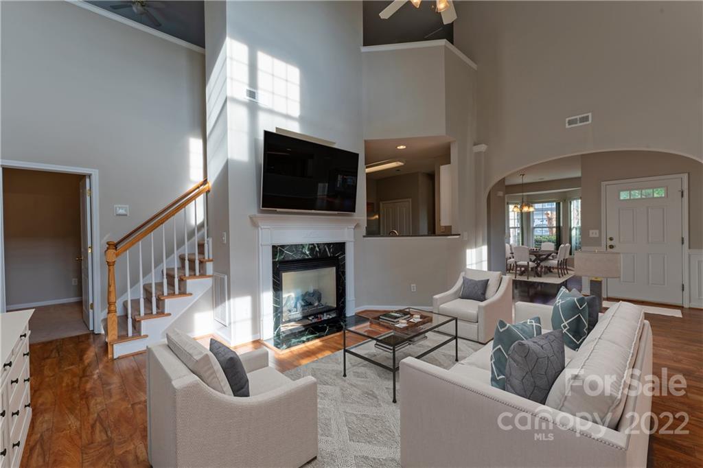 3106 Tanzanite Circle Fort Mill, SC 29708 - Photo 5 of 36 a living room with furniture a fireplace and a flat screen tv