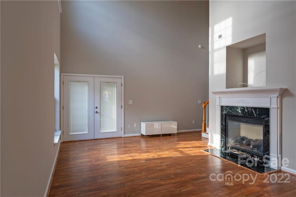 3106 Tanzanite Circle Fort Mill, SC 29708 - Photo 7 of 36 a living room with a fireplace and a wooden floor