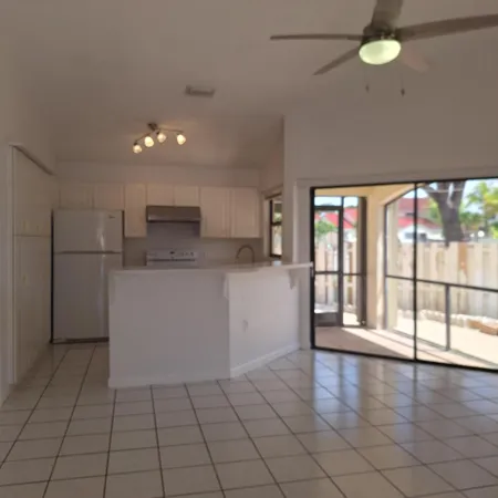 a view of a kitchen with a dishwasher and white cabinets