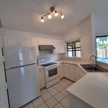 a kitchen with a refrigerator and a sink